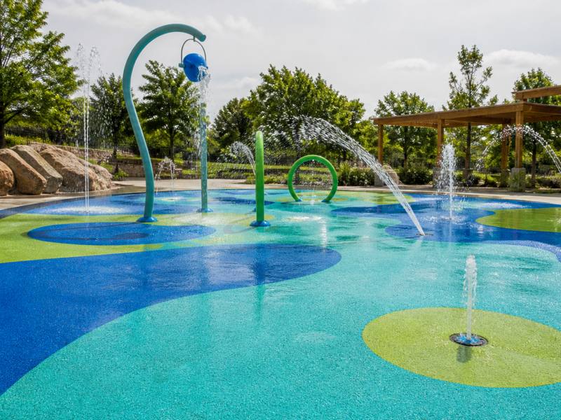 Blue and green rubber surfacing on a splash pad poured by Whitby Rubber Surfacing.