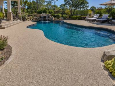 Pool deck with a waterfall in rubber surfacing