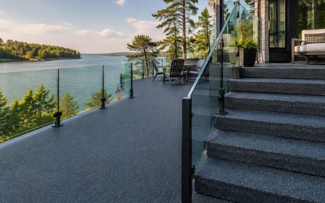 Charcoal rubber surfacing on a waterfront deck and its stairs.