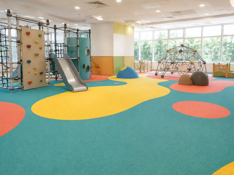 Bright coloured rubber surfacing across the floor of an indoor play centre in Whitby.